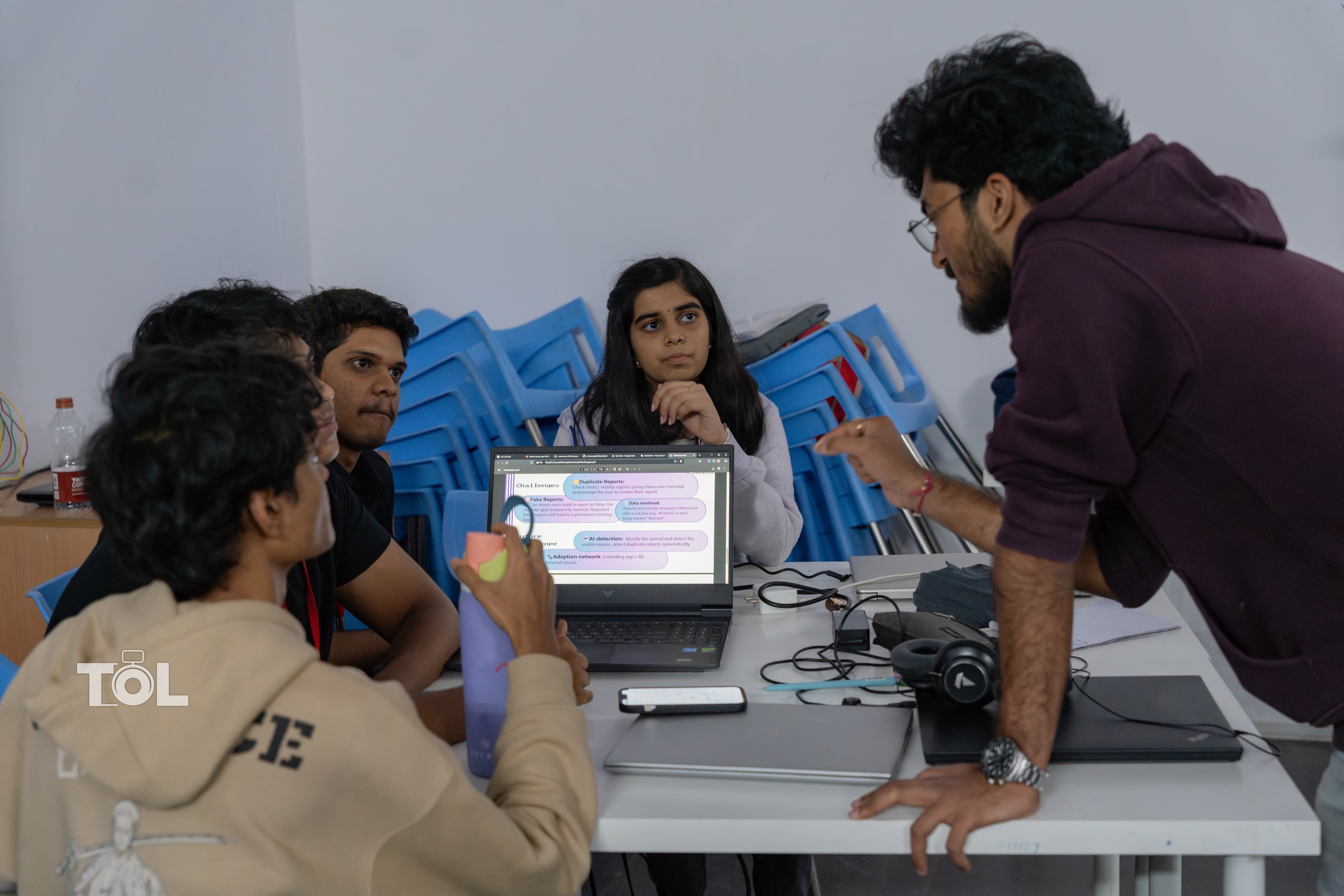 A Codenovate team collaborating around a laptop