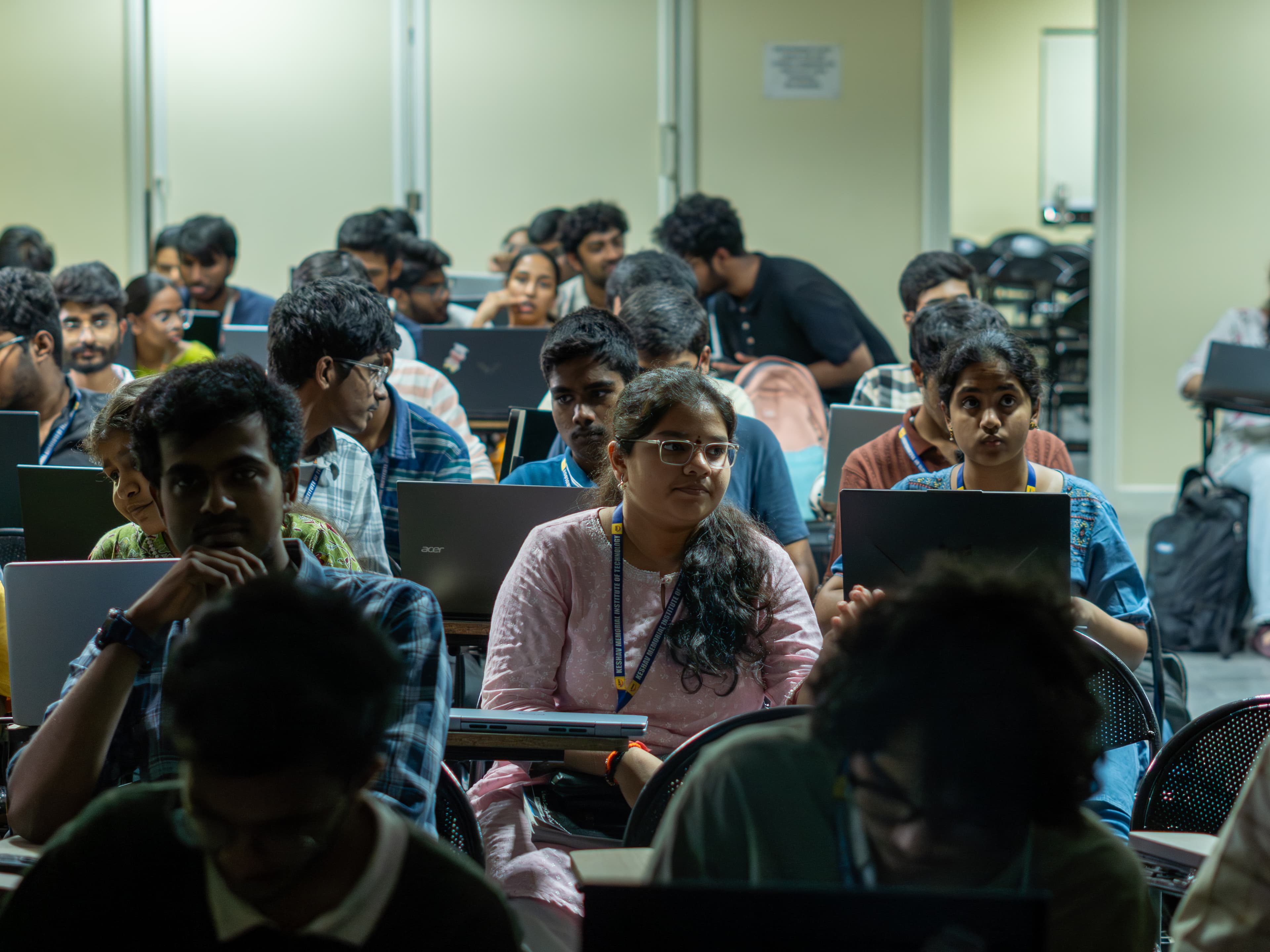 A packed room of students working on their laptops