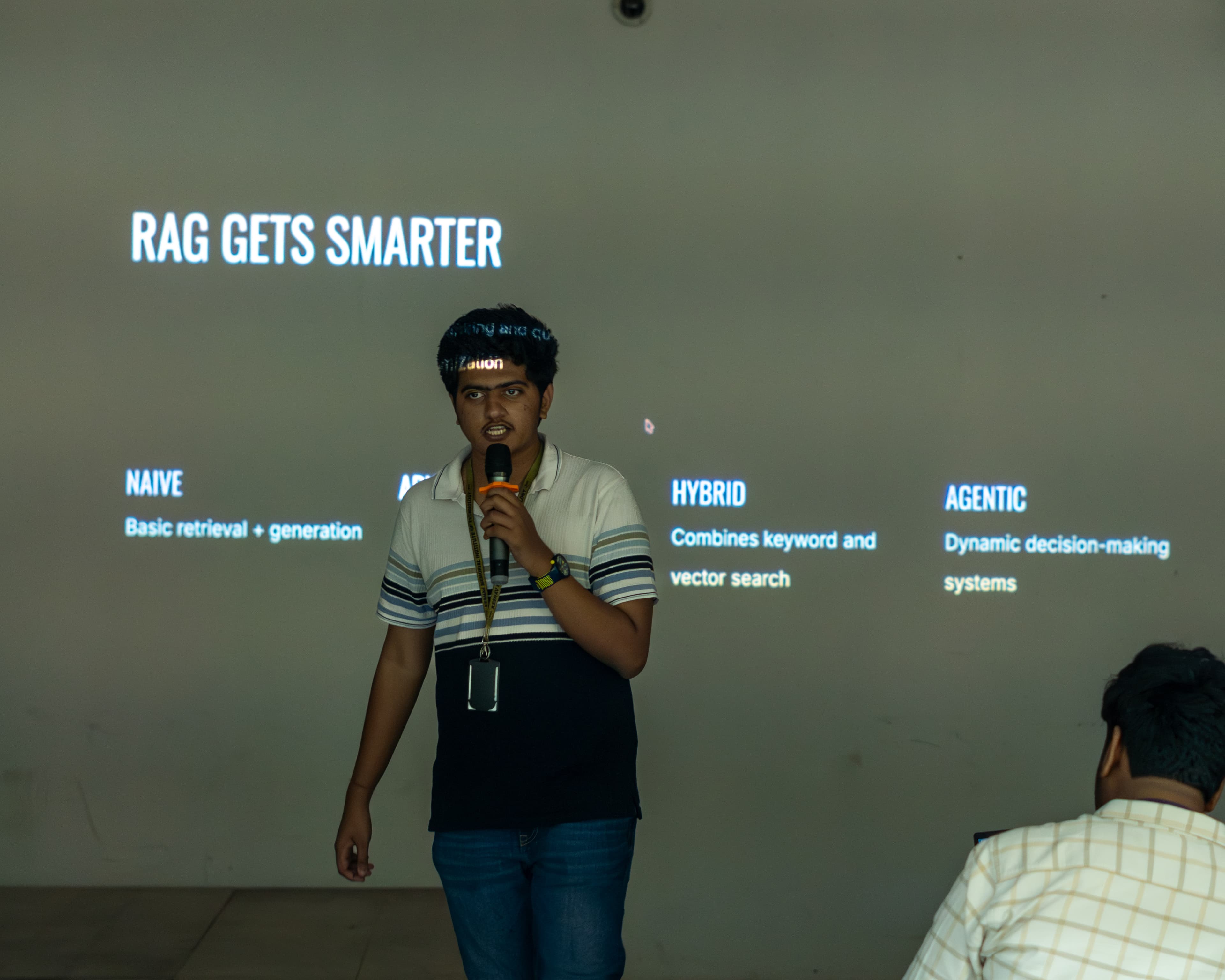 A speaker explaining retrieval-augmented generation at ReBoot